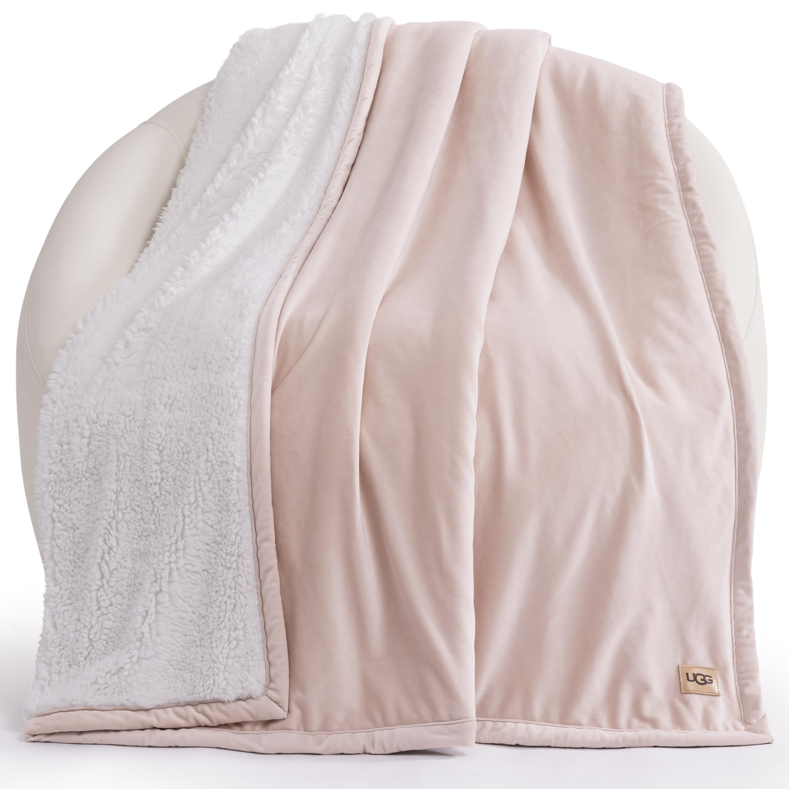 UGG Bliss Throw Blanket with reversible design, pink fleece and fluffy backing for bed or couch.