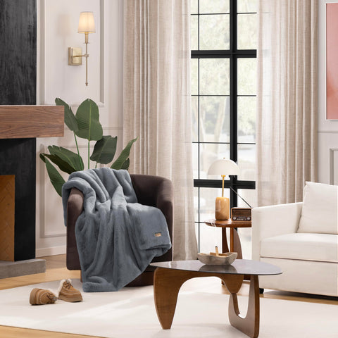 UGG Euphoria plush faux fur throw back view, softens chairs or beds.