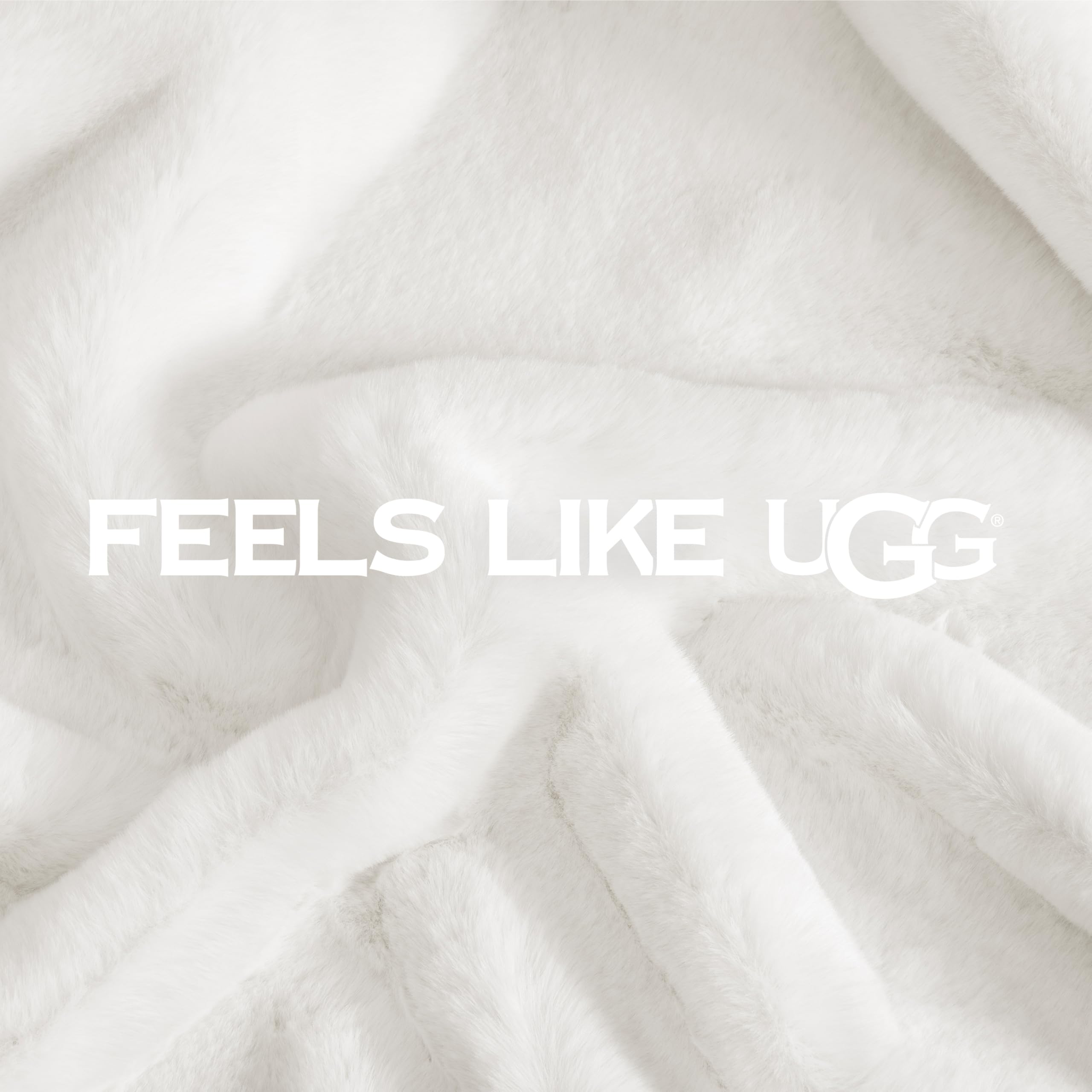UGG Euphoria plush fur throw on bed adds a plush decorative layer to bedding