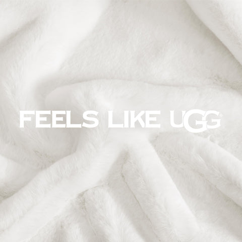UGG Euphoria plush fur throw on bed adds a plush decorative layer to bedding
