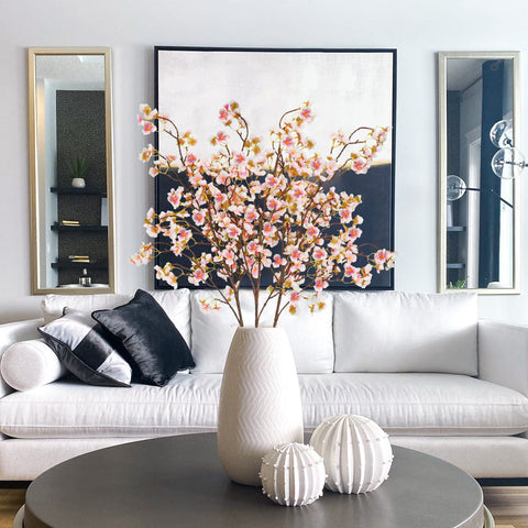 Uieke cherry blossom branch arranged in a vase for elegant decor.