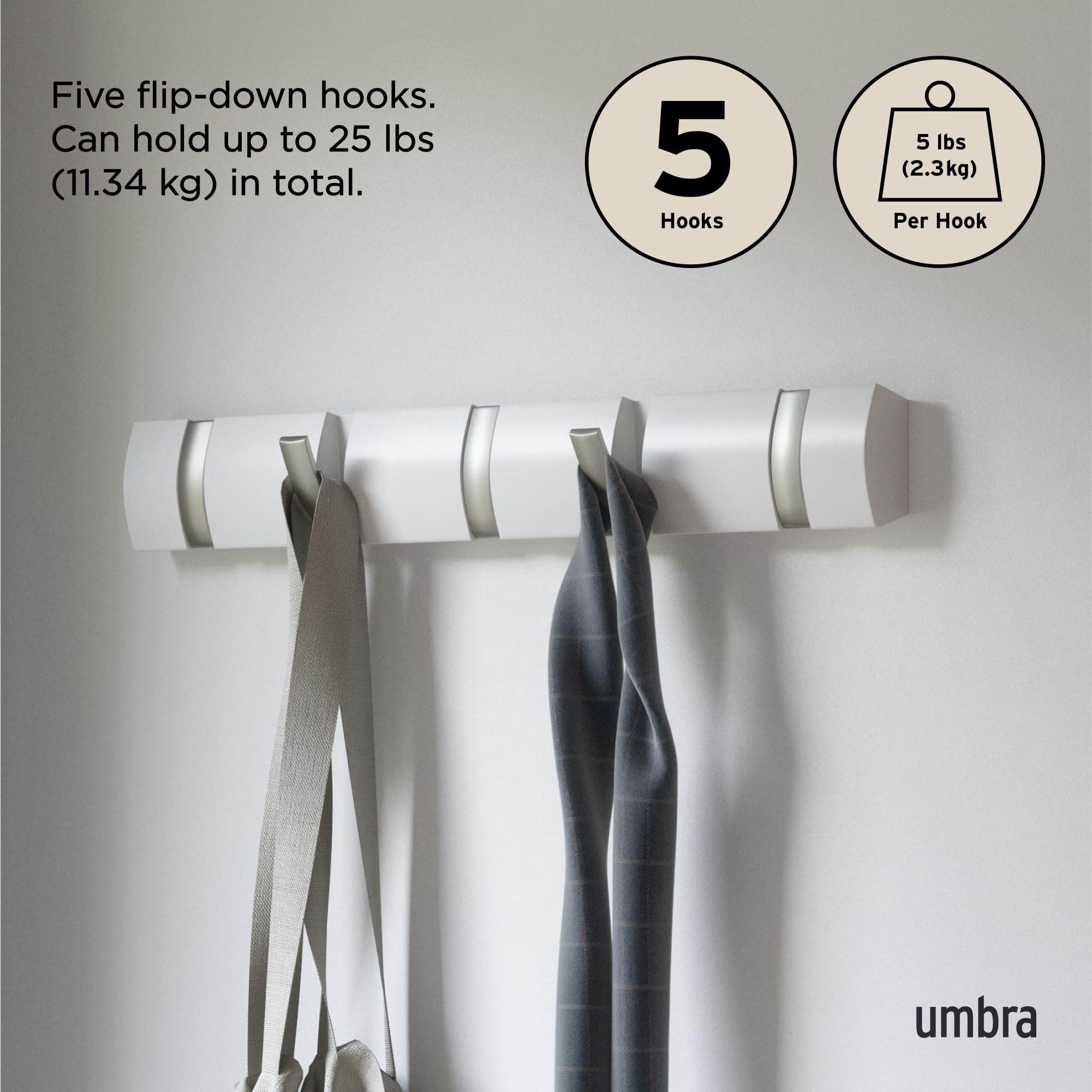 Umbra Flip coats and bags organized on a slim wall rail.
