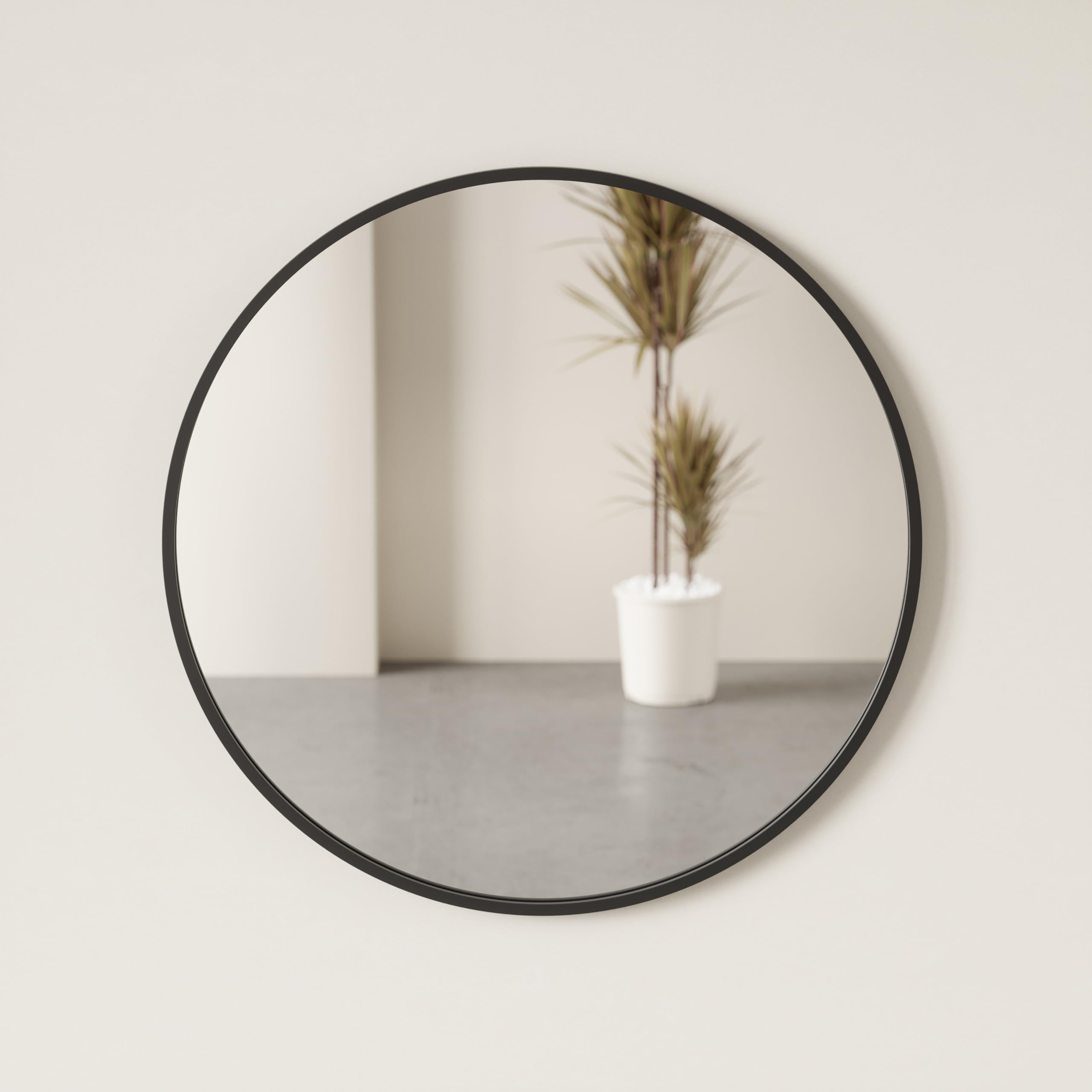 Umbra Hub 37-inch round mirror anchors walls in contemporary spaces