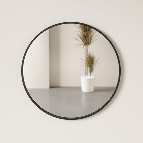 Umbra Hub 37-inch round mirror anchors walls in contemporary spaces