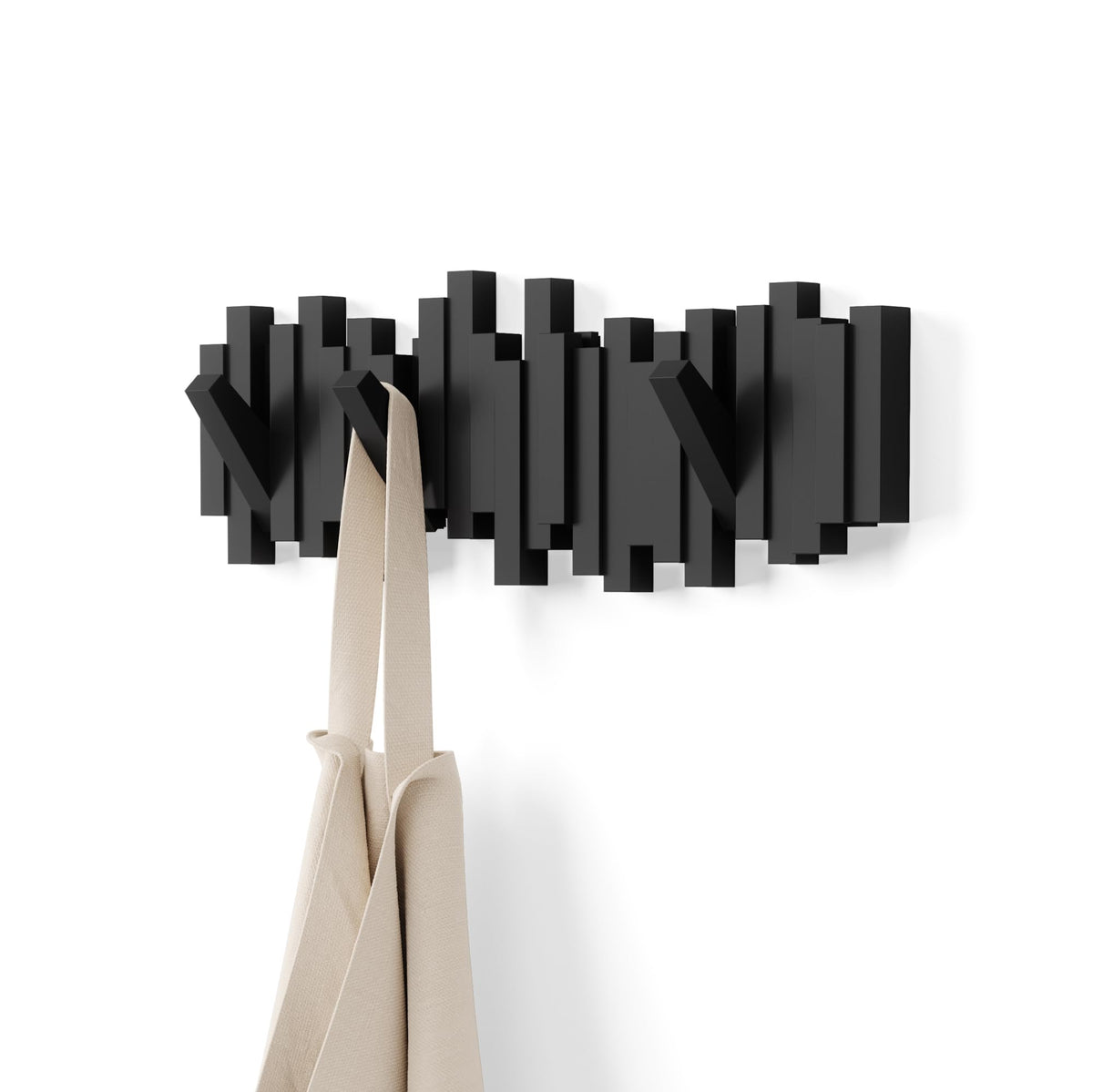 Umbra Sticks wall-mounted coat rack with five retractable hooks for compact entryways.