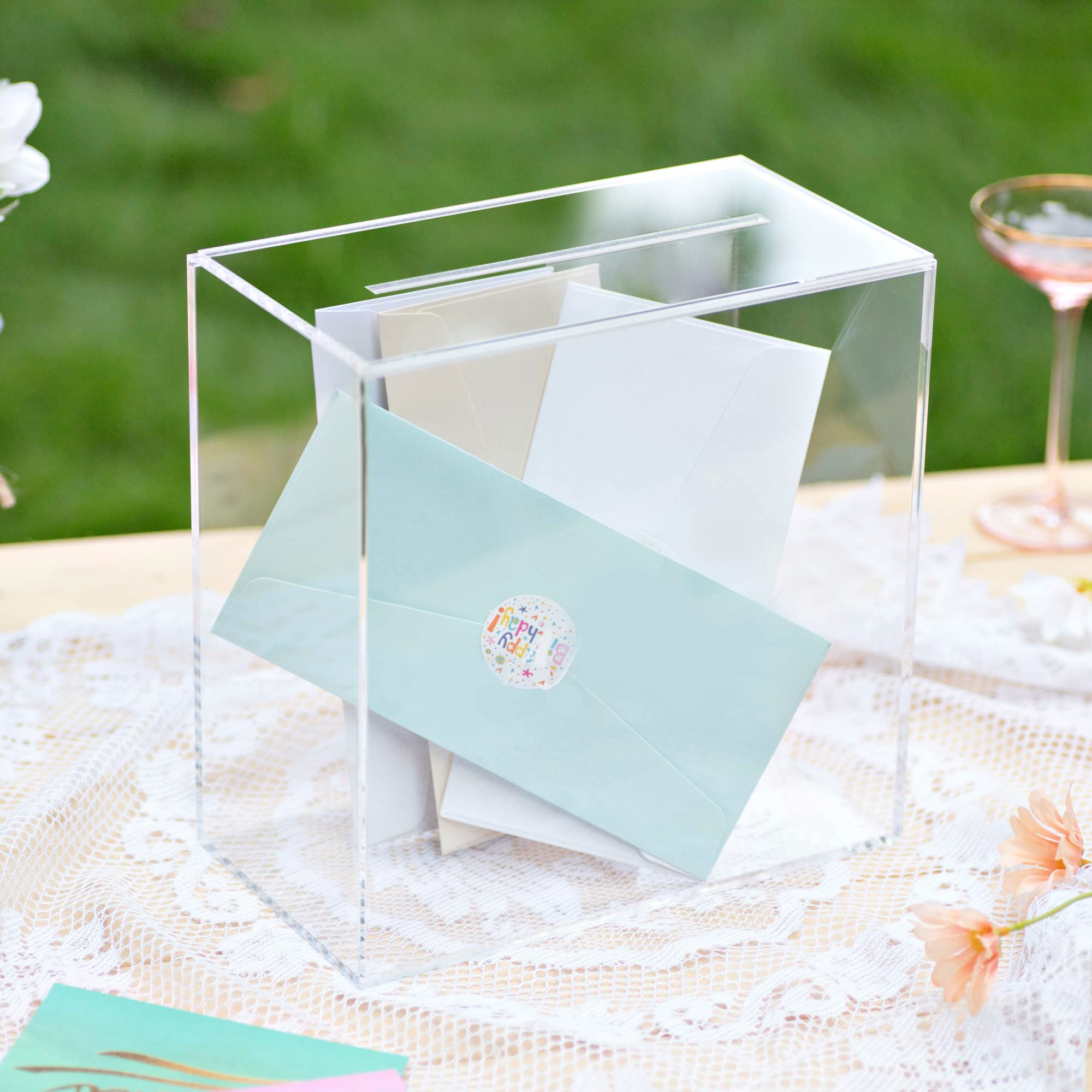 UNIQOOO crystal-clear wedding card box highlighting decorative reception setup