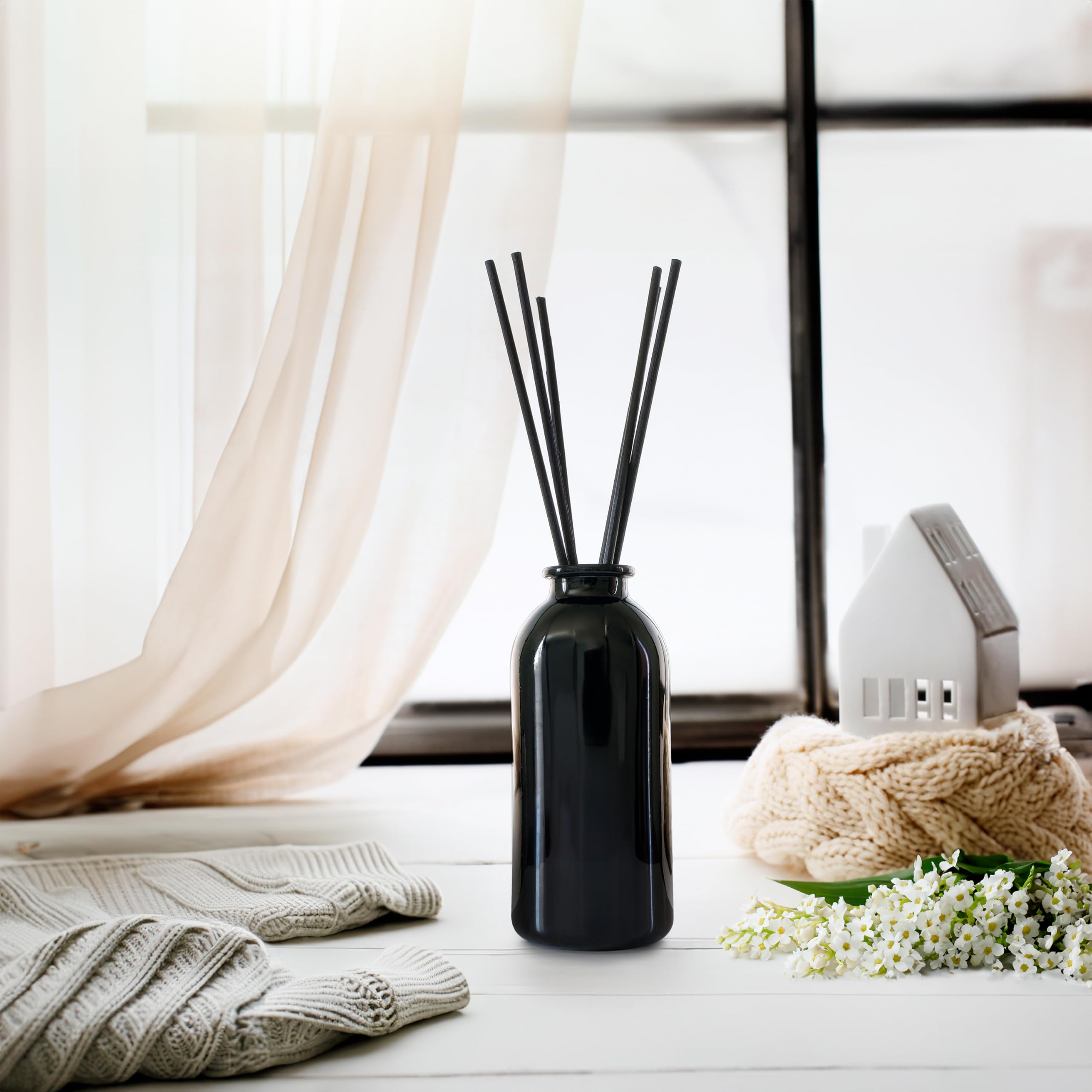 Urban Naturals glass bottle with reeds close-up showing durable design