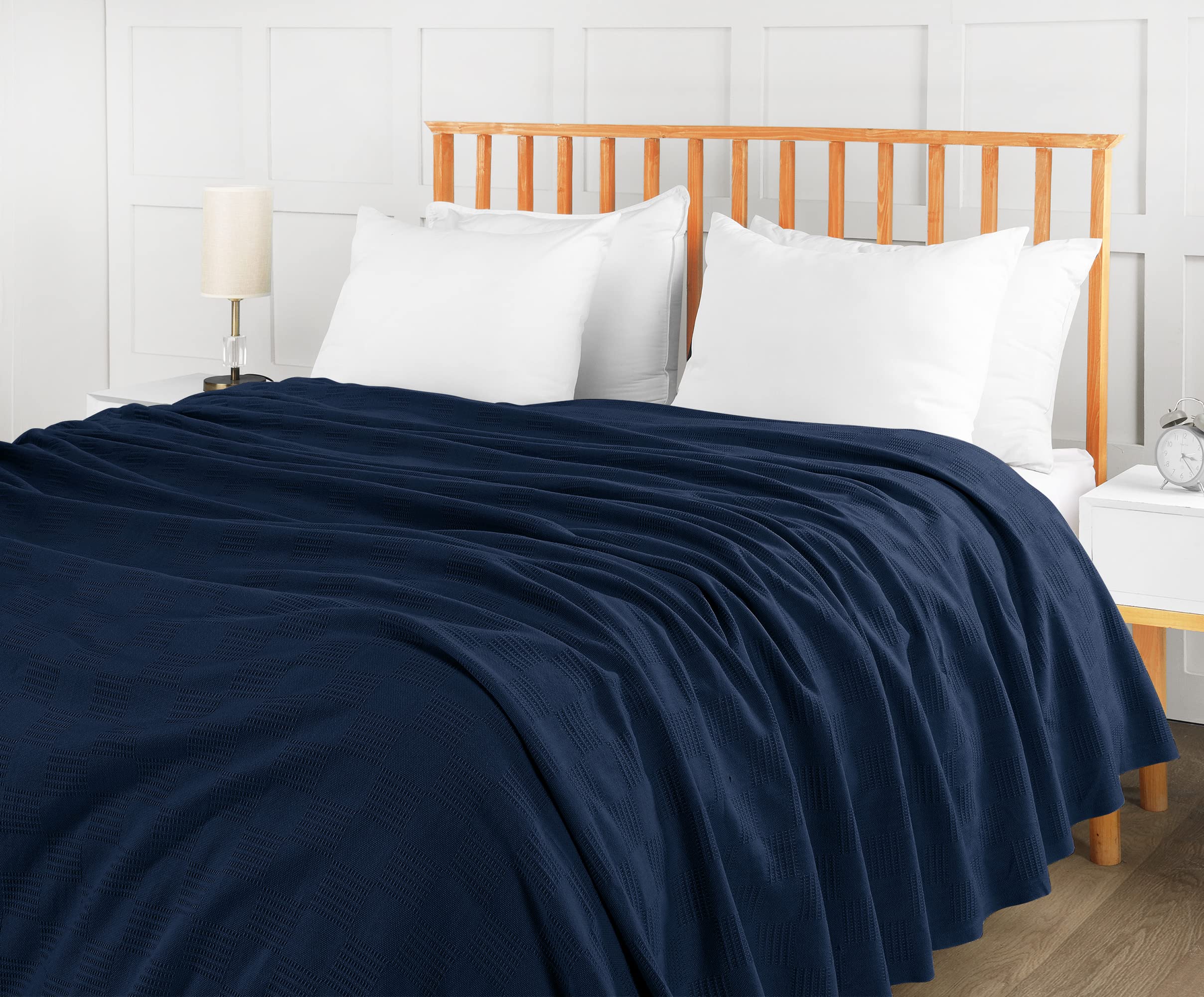 Utopia Bedding navy cotton blanket drapes luxuriously on bed.