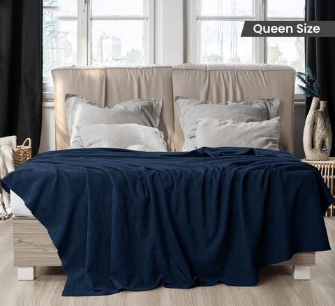 Utopia Bedding navy blanket draped over a queen bed for cozy decor.