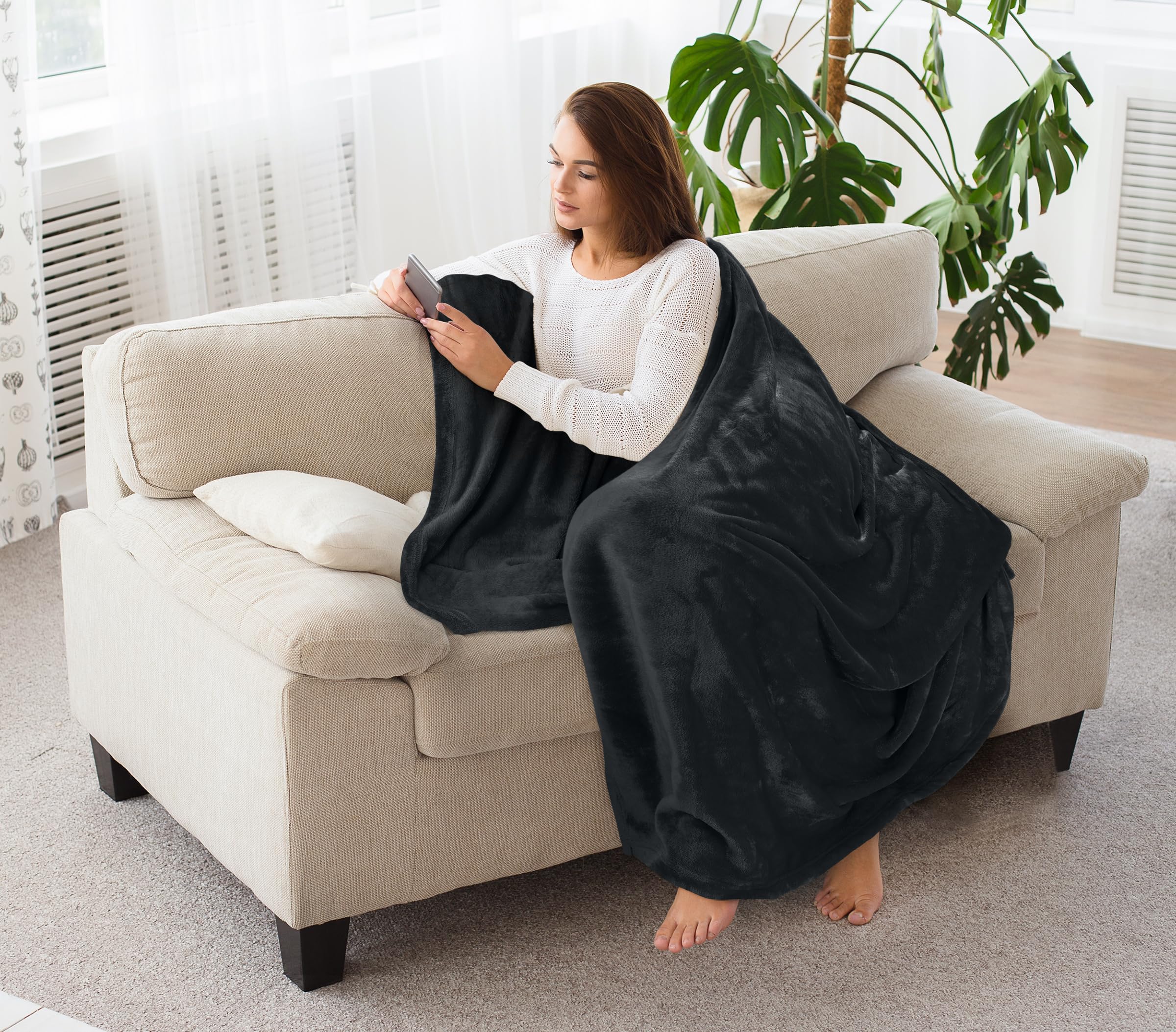 Bed draped with Utopia Bedding blanket for elegant ambiance