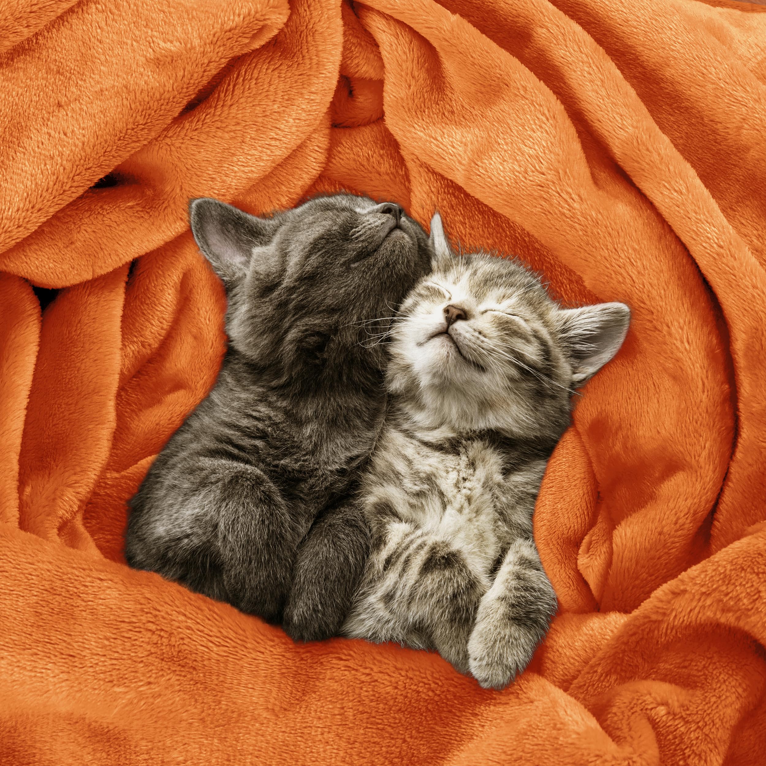 Blanket on bed by Utopia Bedding with burnt orange hue and drape.