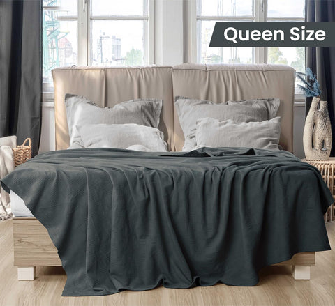 Utopia Bedding breathable cotton blanket draped on a couch for cooling comfort.
