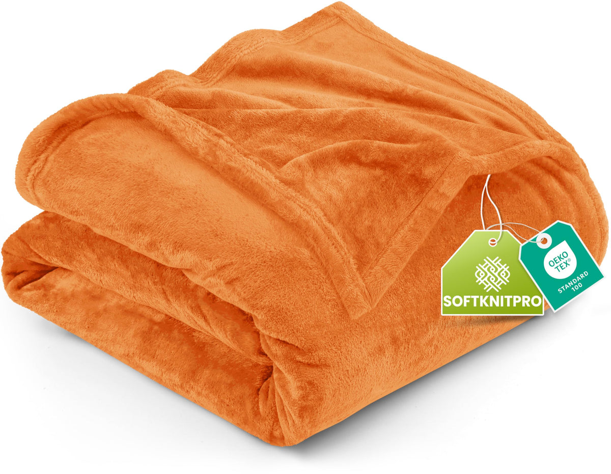 Utopia Bedding fleece blanket on queen bed shows warm, lightweight comfort in burnt orange.