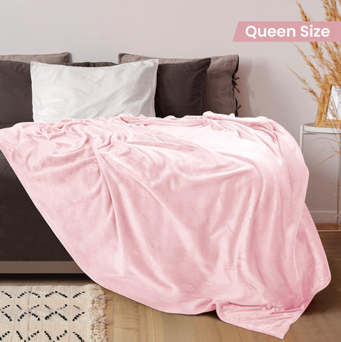 Utopia Bedding fleece blanket on a bed in pink adds warm, inviting texture.