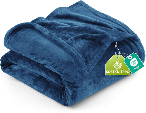 Utopia Bedding fleece blanket in royal blue draped on a bed for cozy warmth.