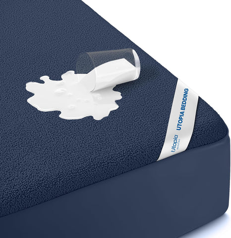 Utopia Bedding king mattress protector full coverage on a king bed for dry, clean sleep.