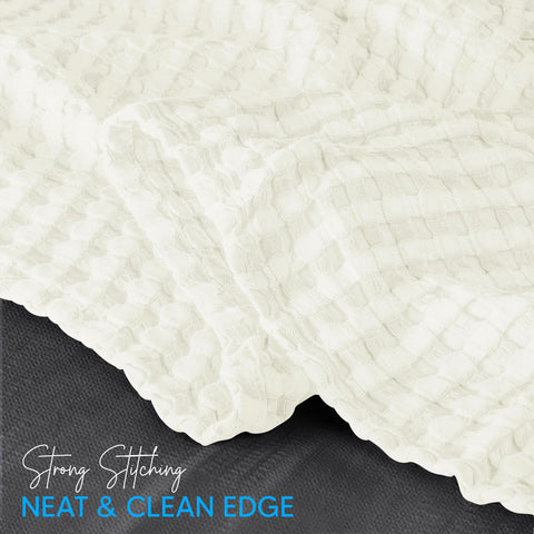 Lightweight Utopia Bedding blanket draped over couch for daily comfort.