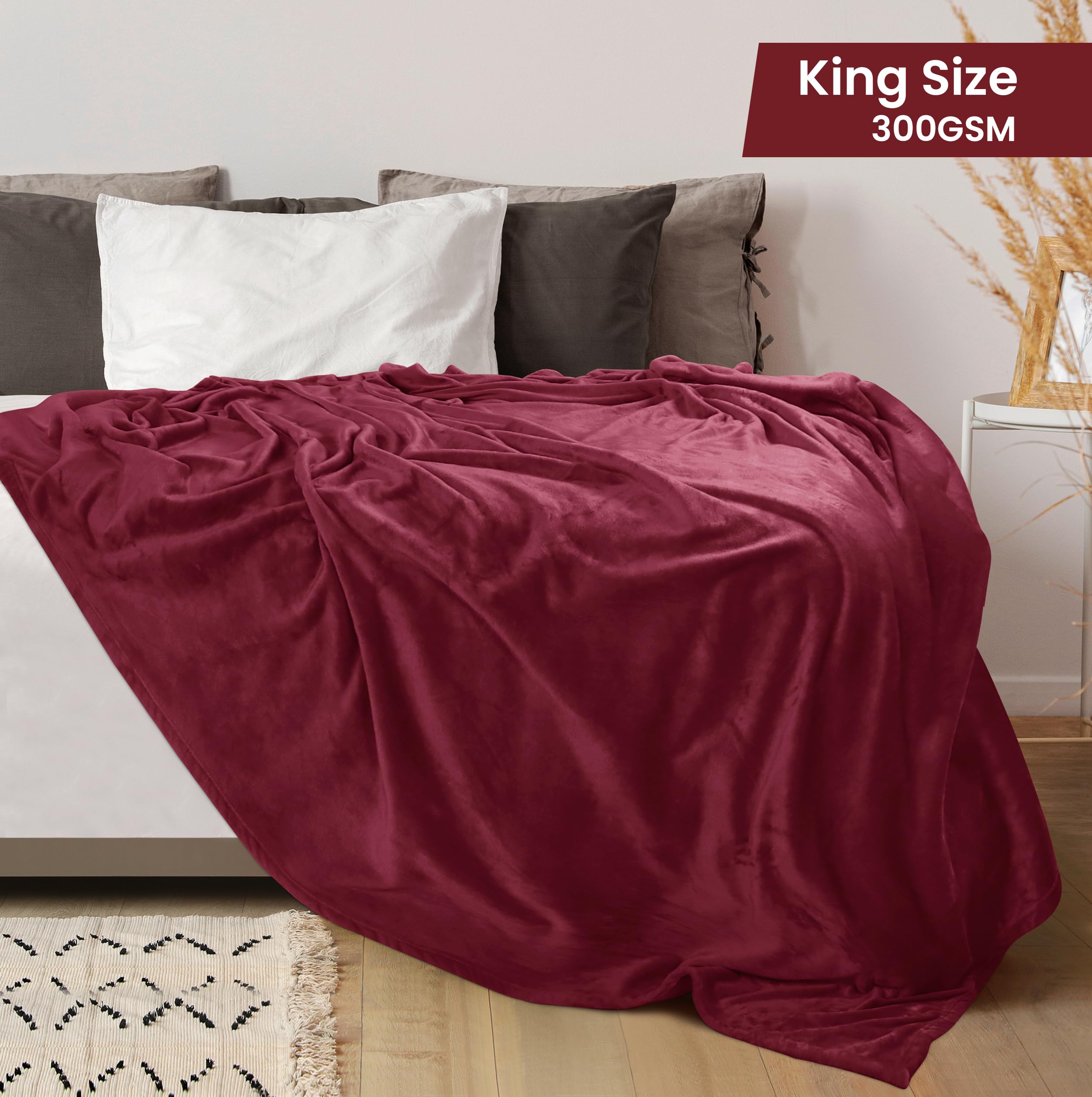 Utopia Bedding luxury fleece blanket burgundy draped over a bed.