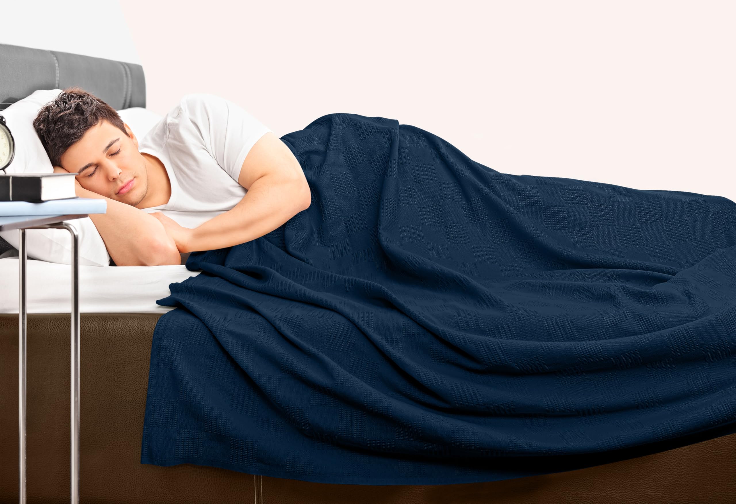 Navy Utopia Bedding blanket placed on bed to showcase size and drape.