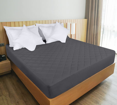 Grey Utopia Bedding quilted fitted mattress pad in a calm bedroom scene.