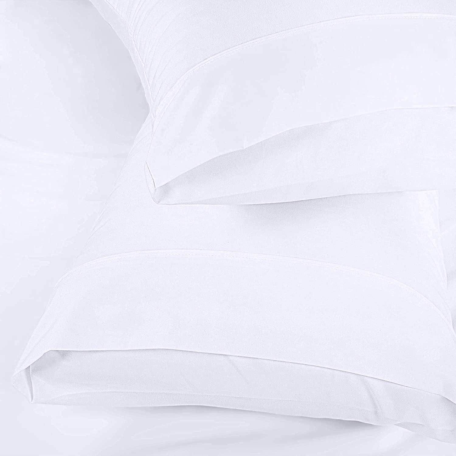Utopia Bedding white pillowcases on a neatly made bed.