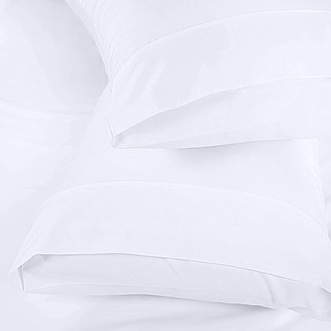 Utopia Bedding white pillowcases on a neatly made bed.