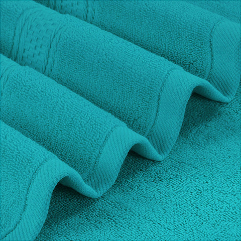 Utopia Towels 4 Pack folded turquoise towels demonstrating generous size and easy storage.