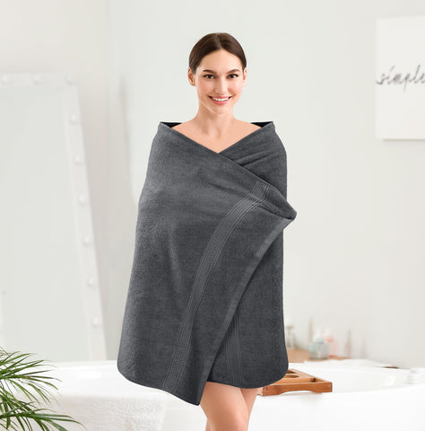Grey towels stacked in a drawer, stylish bathroom accessory.