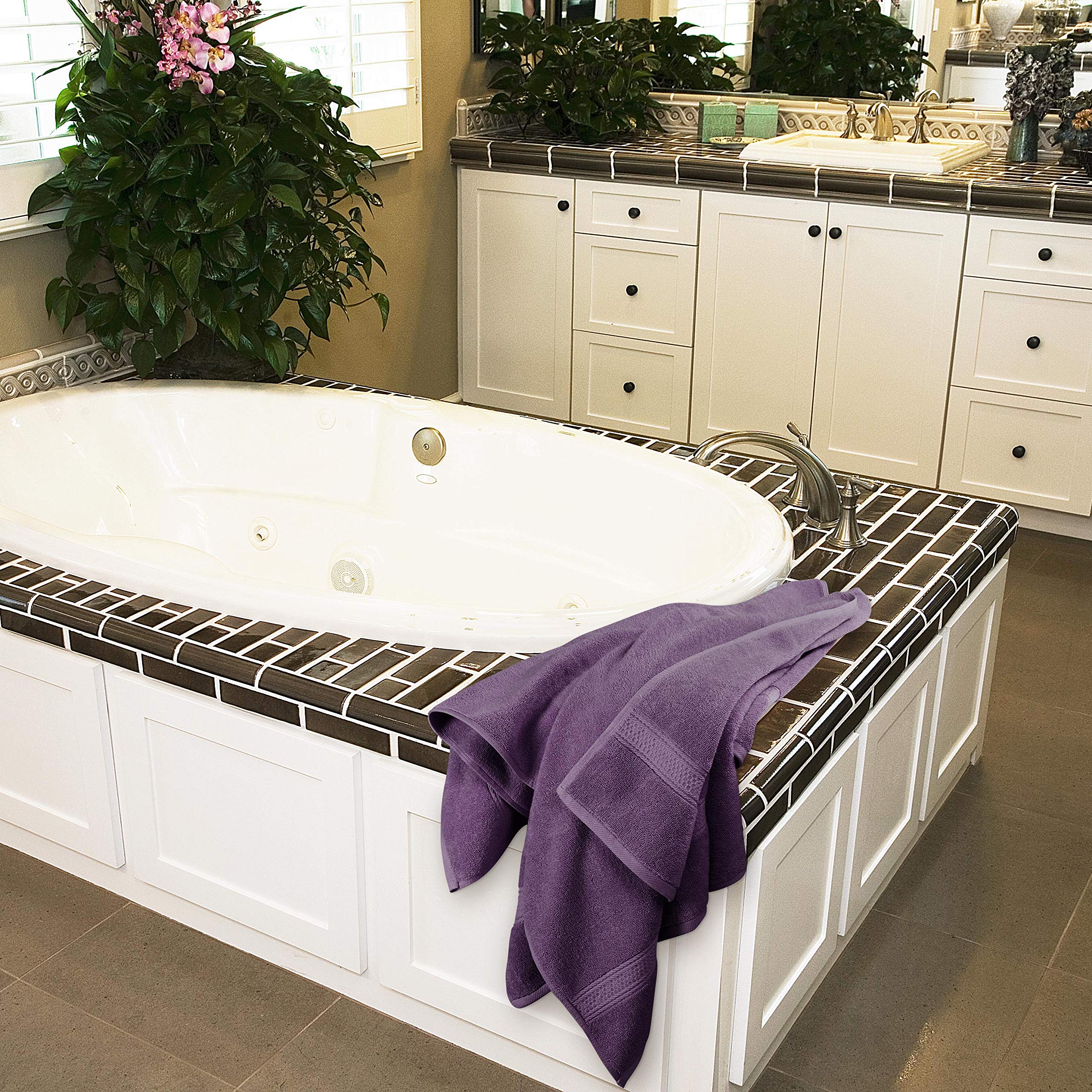 Utopia Towels plum towel pictured at poolside for fast moisture absorption.
