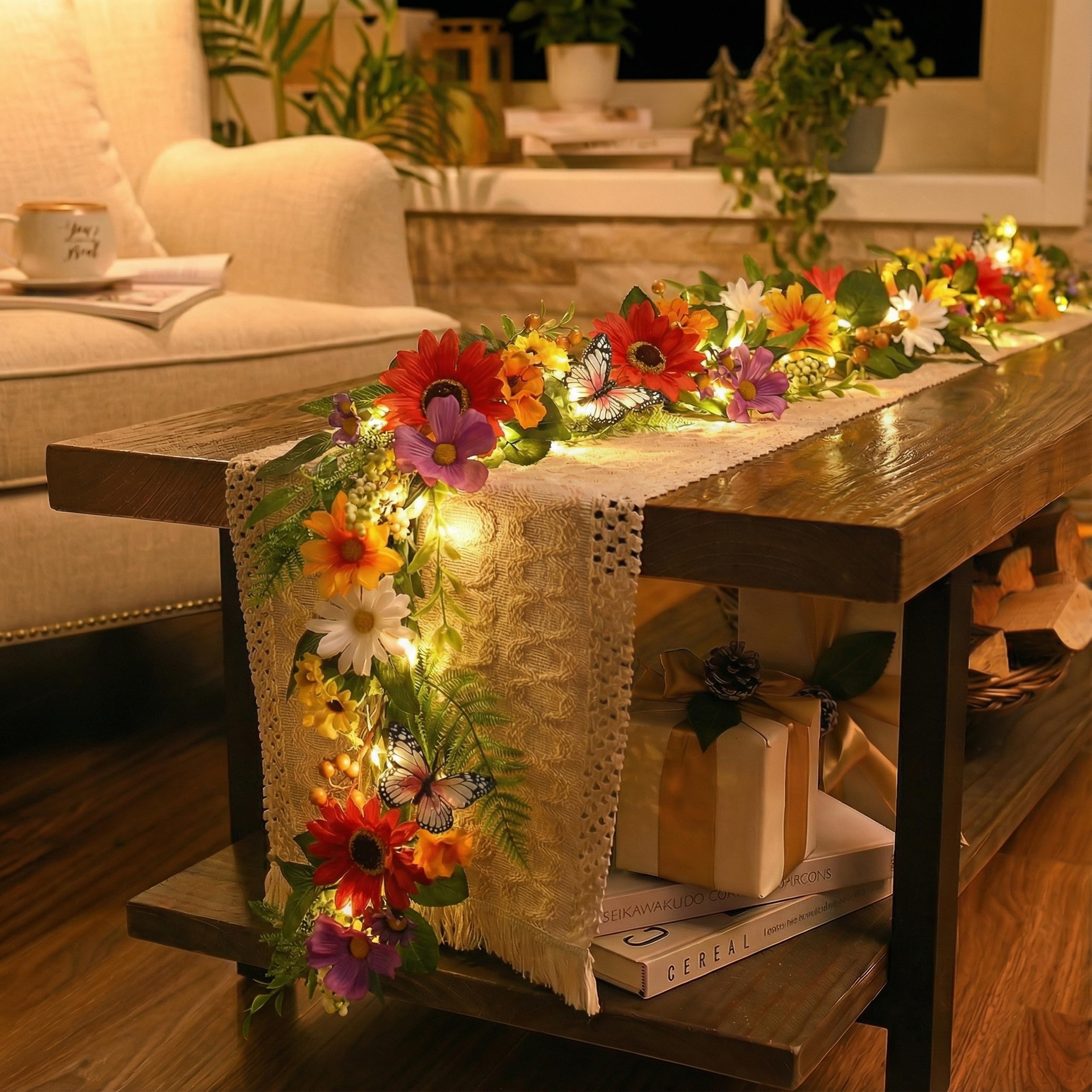 Valery Madelyn daisy-leaf garland highlights a cozy fireplace backdrop with soft ambient lighting.