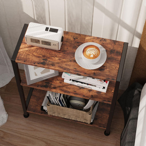 Bedside use: Vantimo 3-Tier Side Table beside a bed with a lamp.