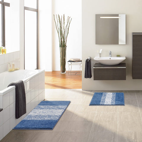 Vaukki blue striped rug complements towels and decor.