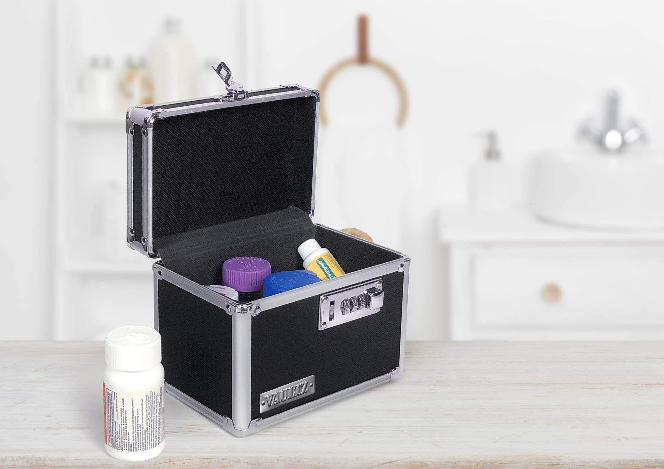 Vaultz locking medicine box lid open showing organized interior compartments for pills