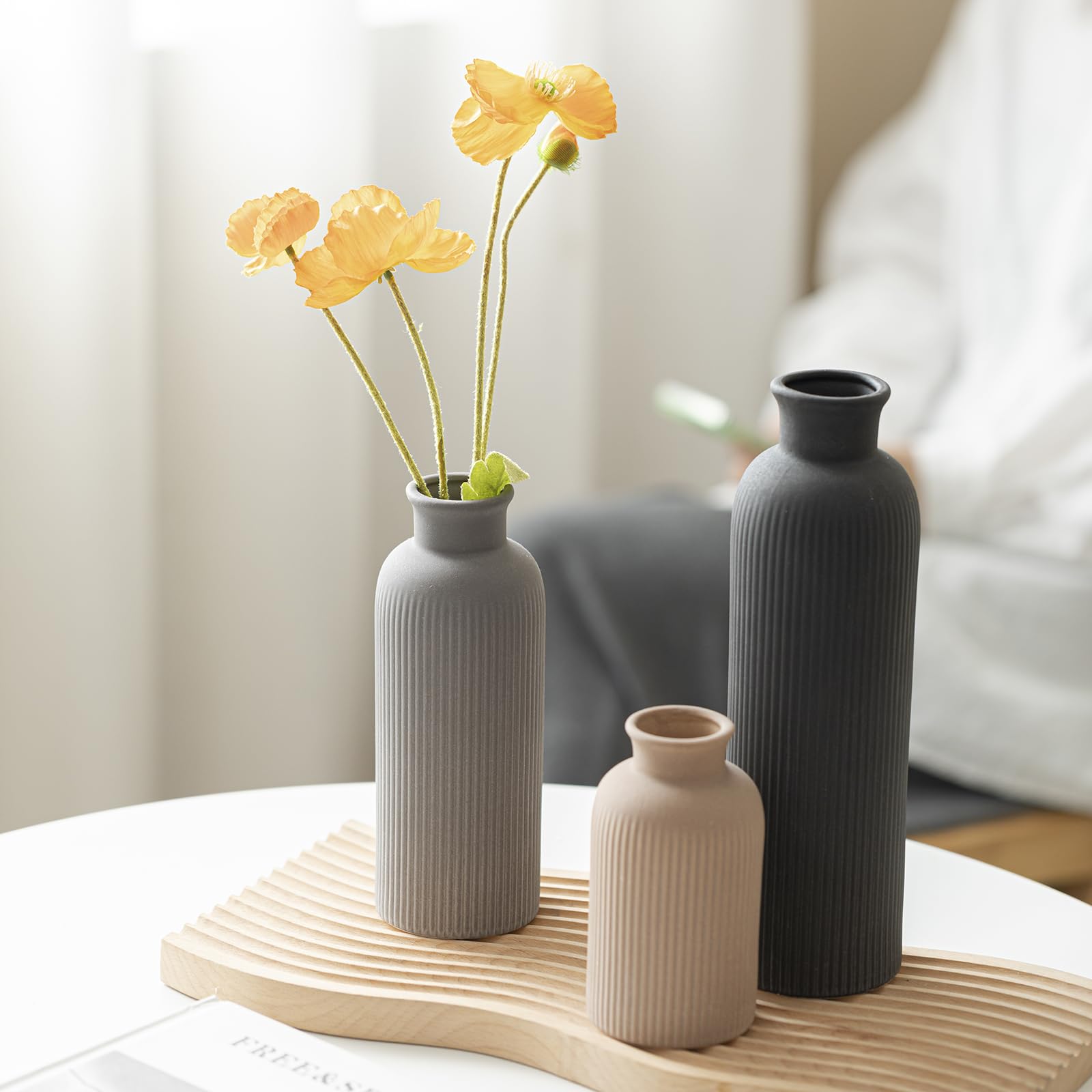 Vaurcesa decorative vases on kitchen shelf with natural botanicals.