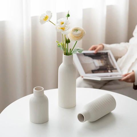 Vaurcesa waterproof-coated vases support fresh stems or dried arrangements.