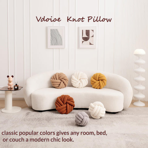 Vdoioe round knotted pillow enhances bed or couch with soft texture.