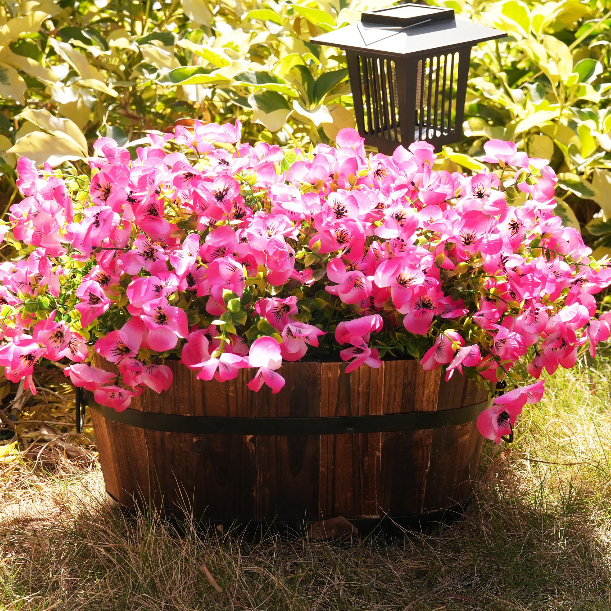 Vemander pink faux pansies in hanging planters for balcony décor.