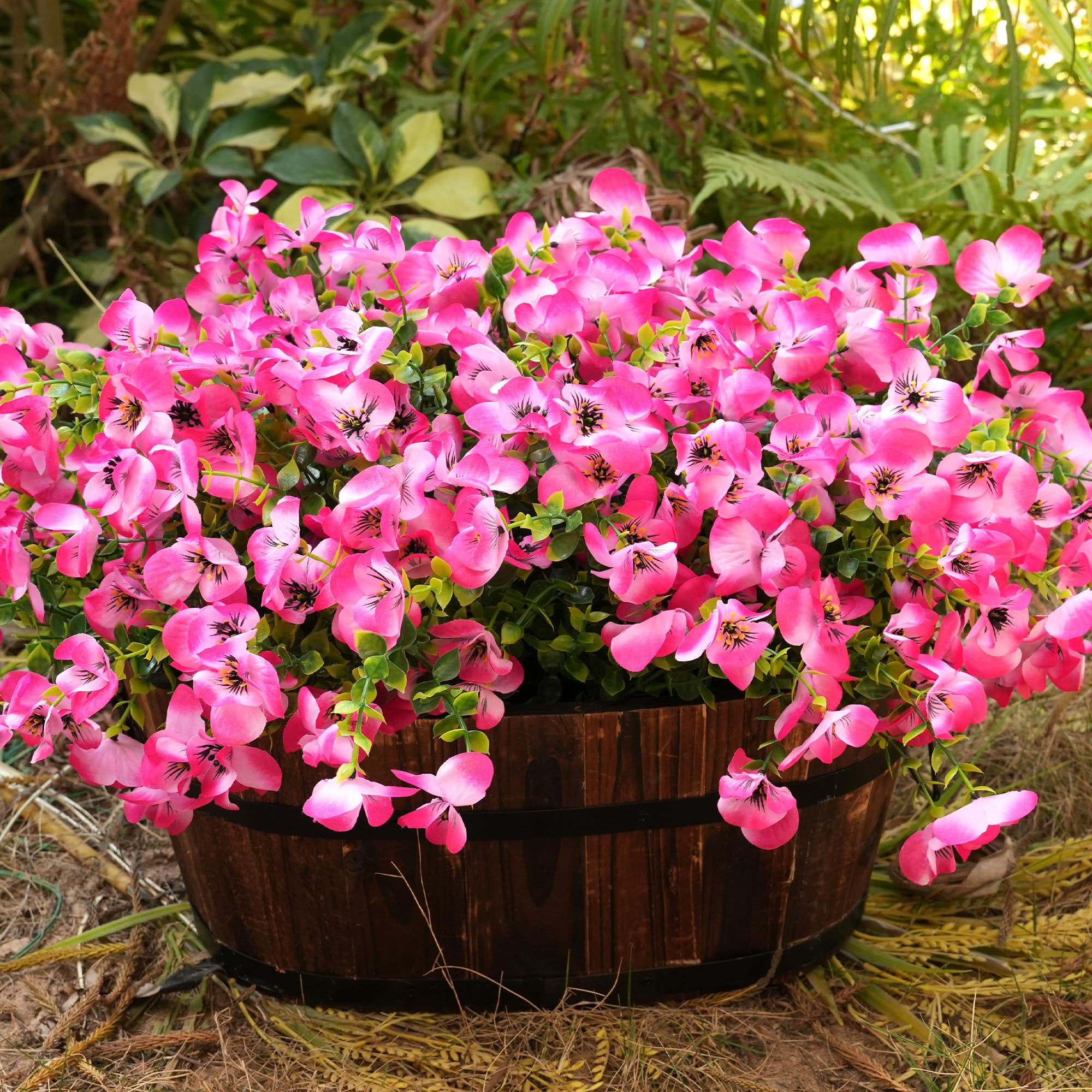 Vemander pink pansy stems with green eucalyptus accents for natural look.