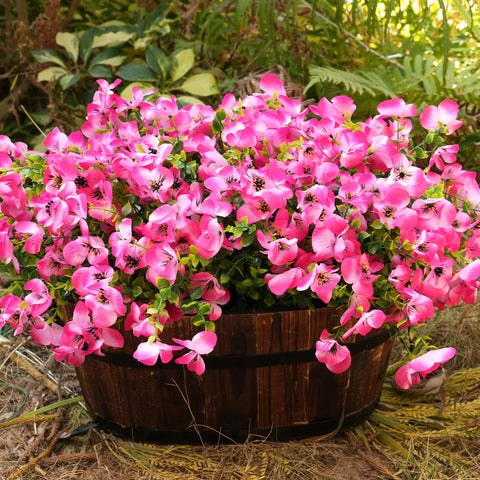 Vemander pink pansy stems with green eucalyptus accents for natural look.