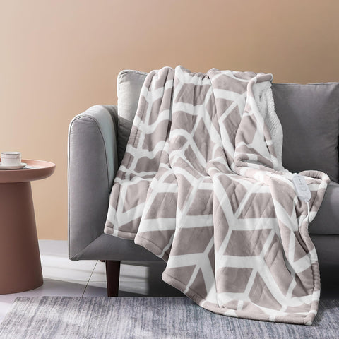Ventimi beige electric blanket throw on sofa for cozy warmth.