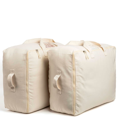Four carrying handles help move bulky linens safely.