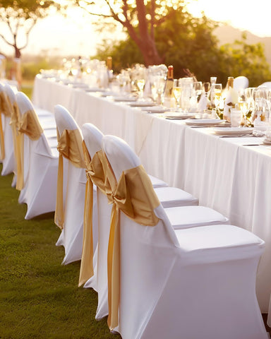 Outdoor event setup featuring white VEVOR chair covers for decor
