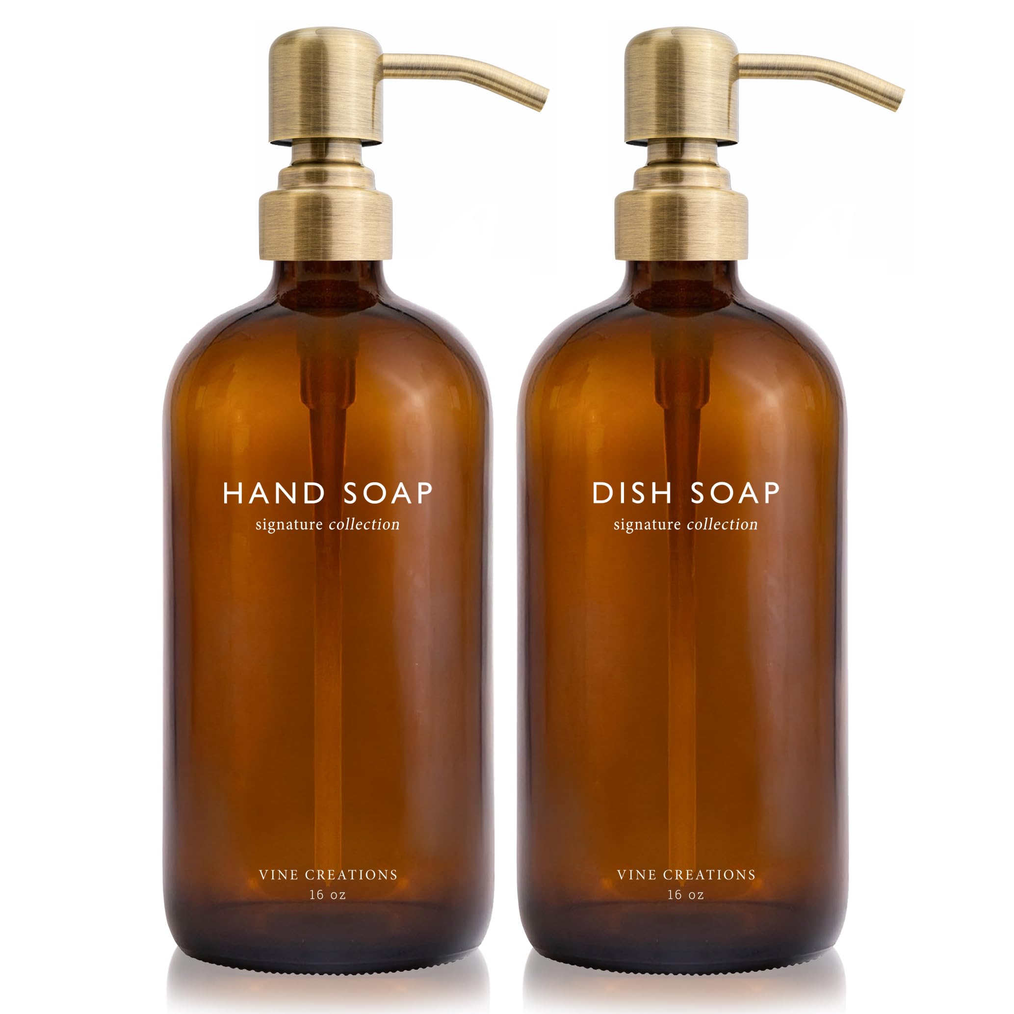 Vine Creations amber glass soap dispenser set with a brushed brass pump on the countertop.