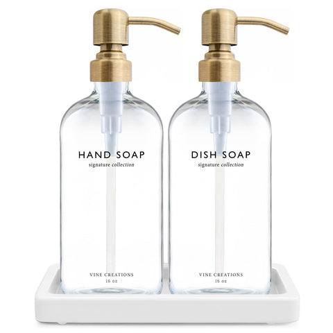 Vine Creations glass soap dispenser set with brushed brass pumps on a stylish counter.