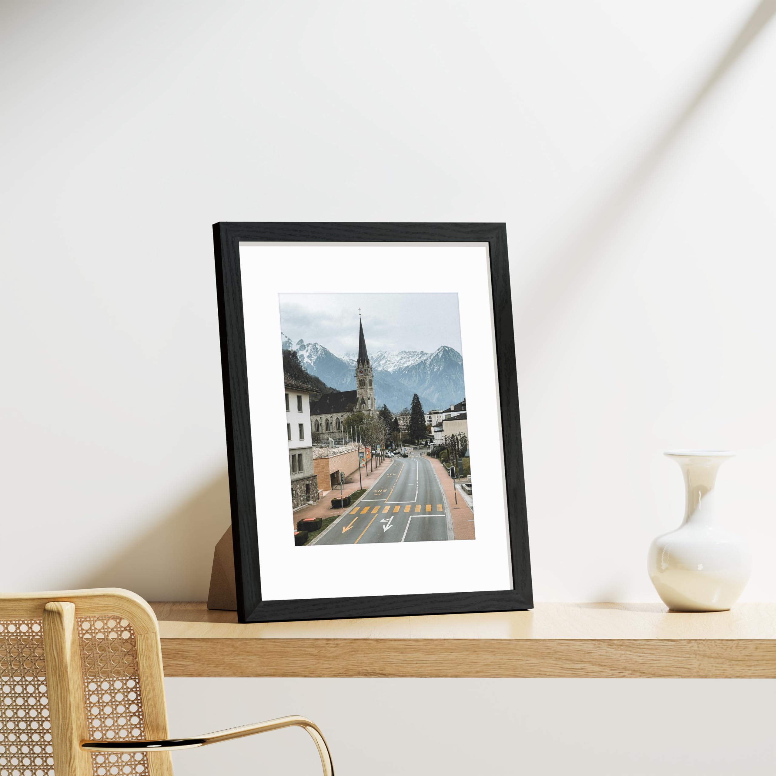 Nine frames mounted on a wall showcasing a cohesive gallery.
