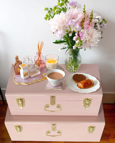 Set of two pink trunks complements dorm decor and keeps clothes organized.