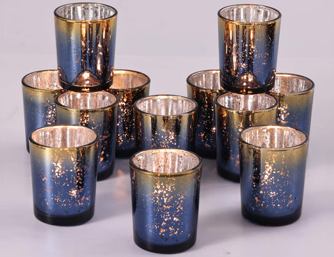 Volens navy votive candle holder with mercury glass finish casts warm speckled light