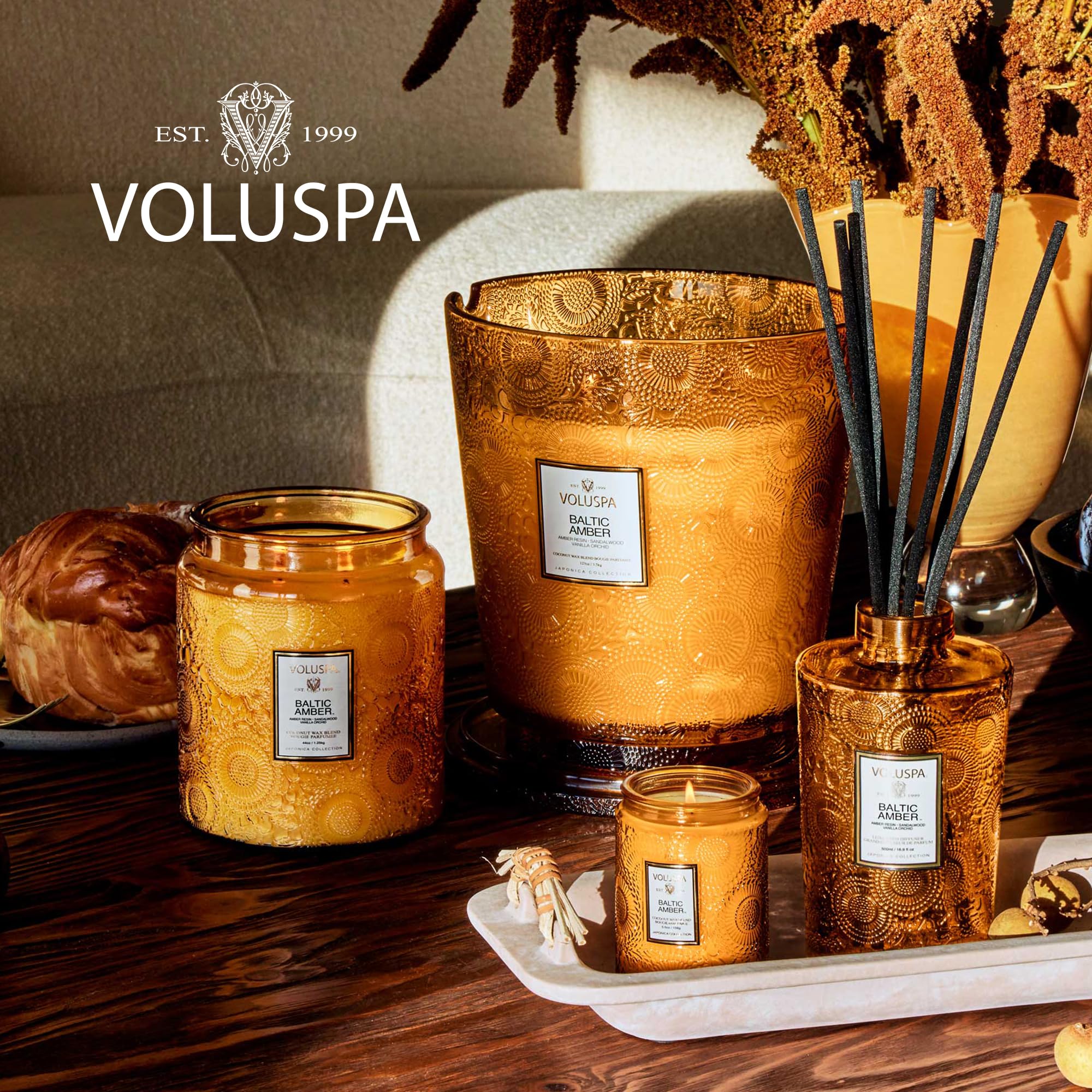 Voluspa Baltic Amber candle on a decorative table with elegant ambiance.