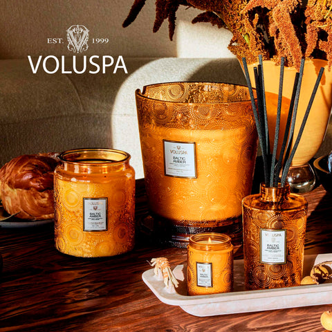 Voluspa Baltic Amber candle on a decorative table with elegant ambiance.