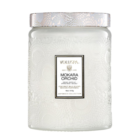 Voluspa Mokara Orchid 18 oz candle in a decorative jar for floral ambiance.